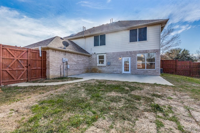 back of house featuring a yard and a patio