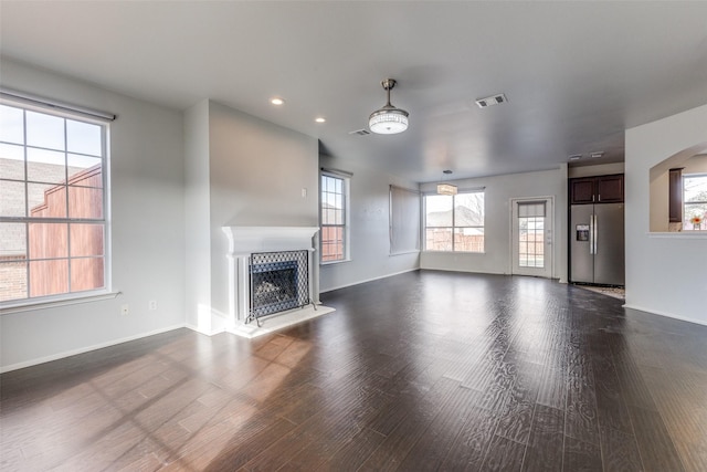 unfurnished living room with dark hardwood / wood-style flooring