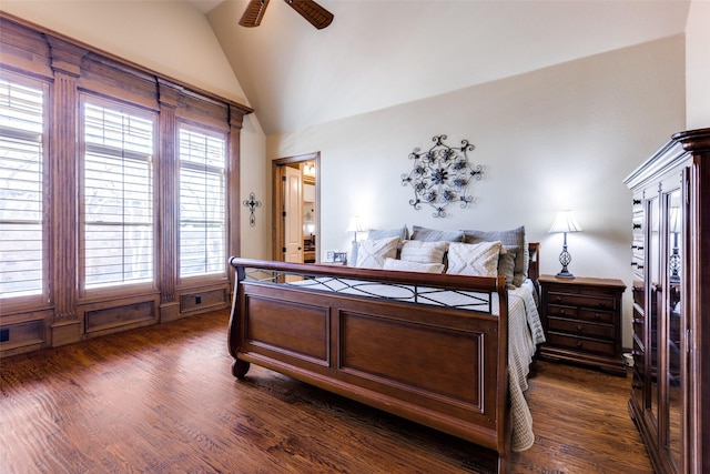 bedroom featuring dark wood-type flooring, vaulted ceiling, and ceiling fan