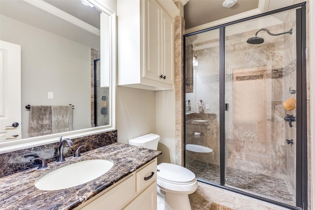 bathroom with vanity, a shower with shower door, ornamental molding, and toilet