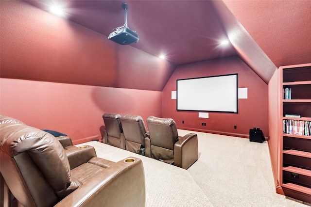 carpeted home theater room with vaulted ceiling and a textured ceiling