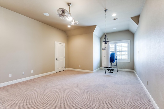 interior space with lofted ceiling and light carpet