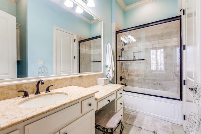 bathroom with vanity, crown molding, and shower / bath combination with glass door