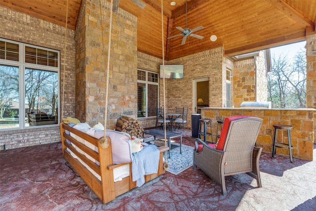 view of patio featuring a bar, an outdoor hangout area, and ceiling fan