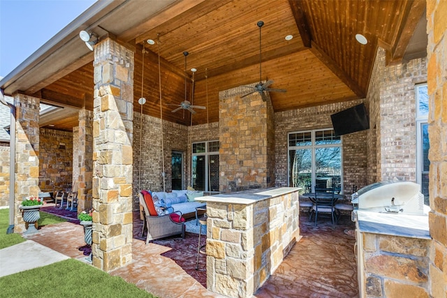 view of patio / terrace featuring outdoor lounge area, an outdoor bar, ceiling fan, and an outdoor kitchen