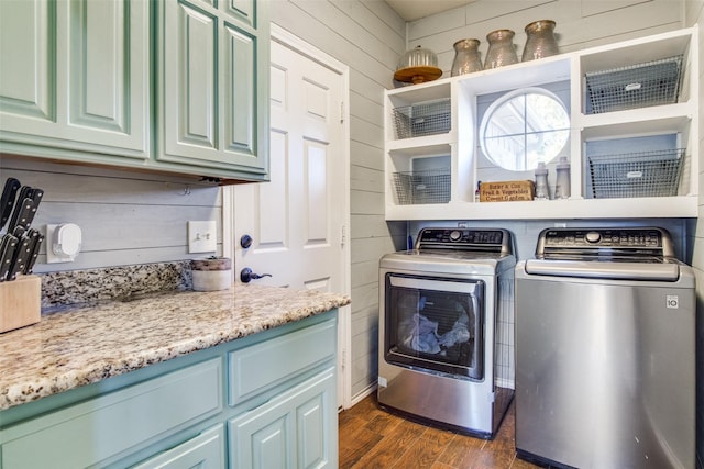 laundry area with washer and dryer, dark wood-type flooring, and cabinets