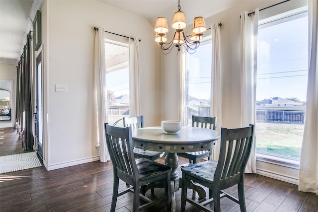 dining space featuring dark wood-type flooring and an inviting chandelier