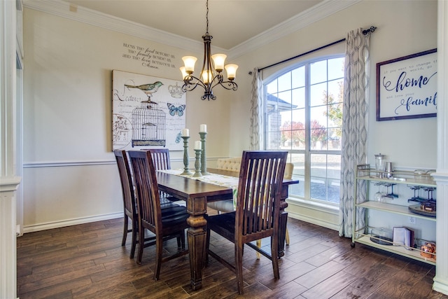 dining area with dark wood-type flooring, ornamental molding, and a chandelier