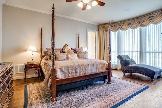 bedroom with ceiling fan, ornamental molding, and wood-type flooring