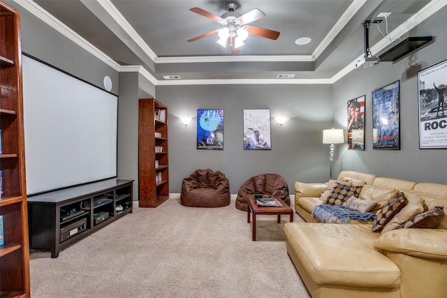 cinema room featuring crown molding, a raised ceiling, ceiling fan, and carpet flooring