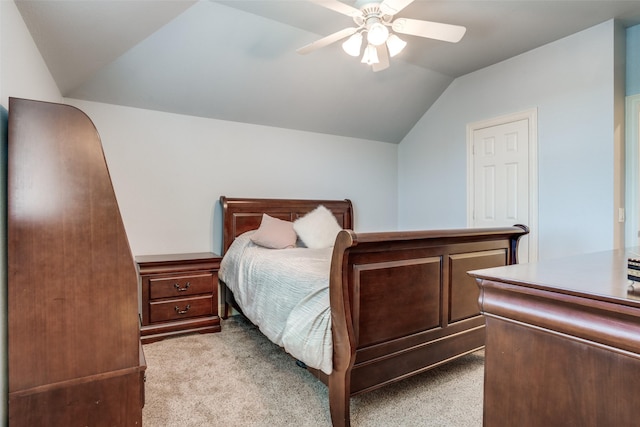 carpeted bedroom featuring lofted ceiling and ceiling fan