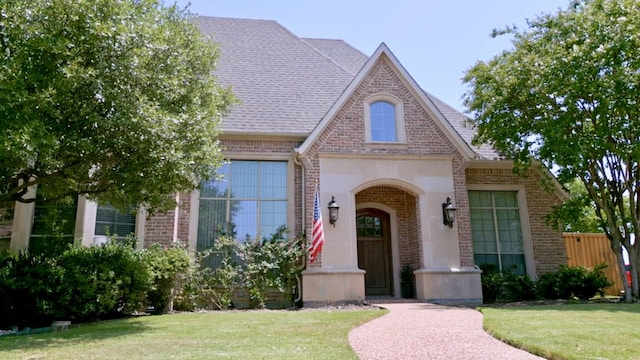 tudor-style house with a front lawn