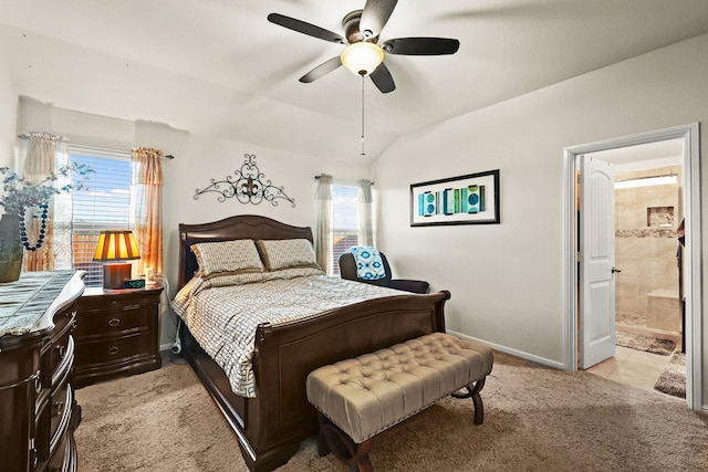 carpeted bedroom featuring multiple windows, connected bathroom, lofted ceiling, and ceiling fan