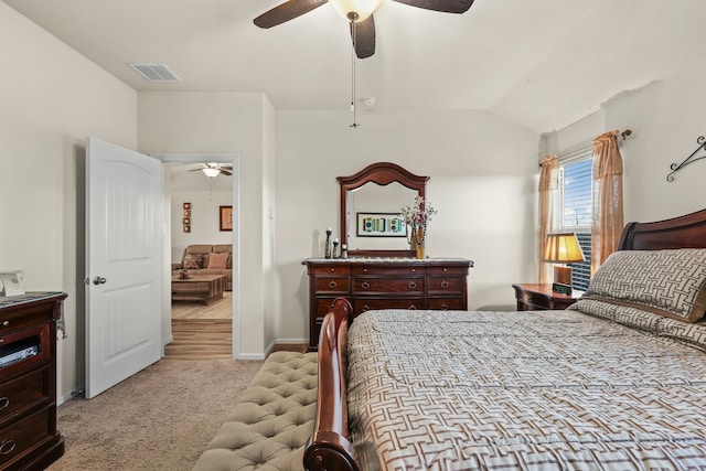 carpeted bedroom featuring vaulted ceiling and ceiling fan