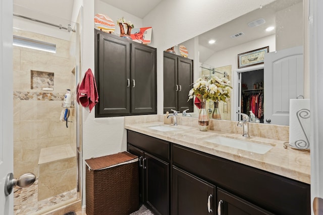 bathroom with vanity and a tile shower