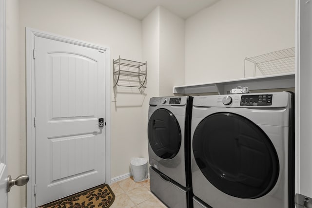 clothes washing area featuring light tile patterned floors and separate washer and dryer