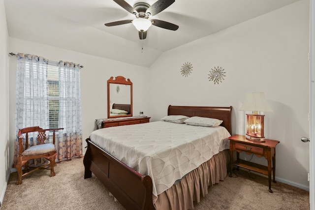 bedroom with ceiling fan, vaulted ceiling, and light carpet