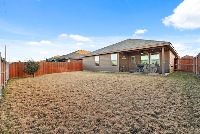 rear view of property with a patio area and ceiling fan