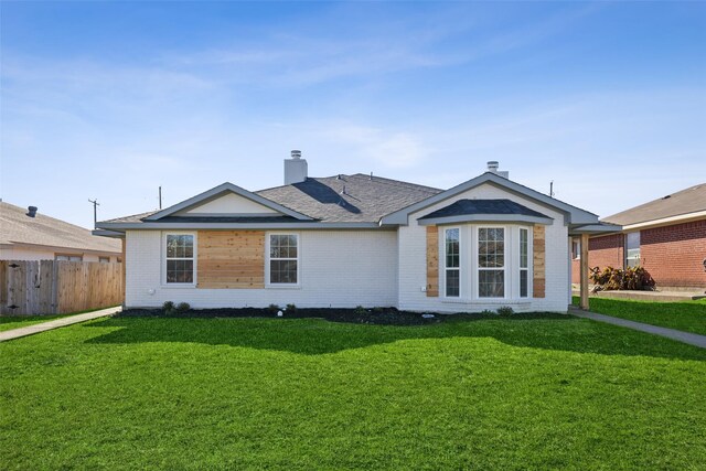 single story home featuring a front lawn