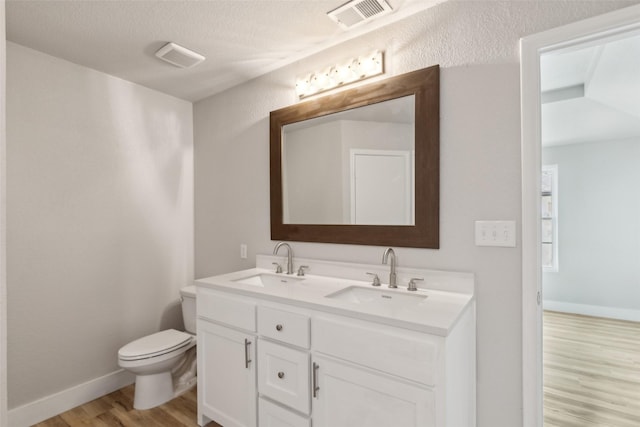 bathroom featuring hardwood / wood-style flooring, vanity, and toilet