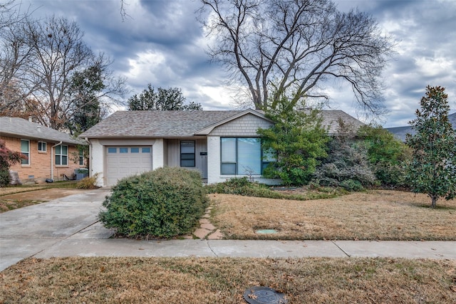 ranch-style house with a front yard and a garage