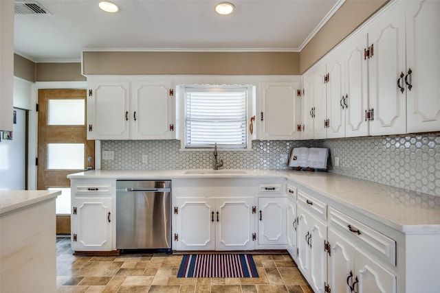 kitchen featuring sink, tasteful backsplash, dishwasher, a healthy amount of sunlight, and white cabinets