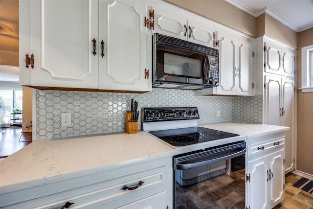 kitchen featuring white cabinets, decorative backsplash, and black appliances