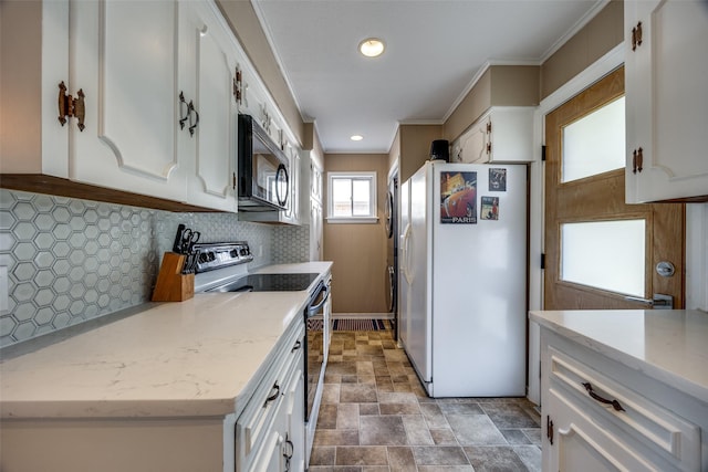 kitchen featuring electric range oven, light stone countertops, white cabinets, decorative backsplash, and white fridge