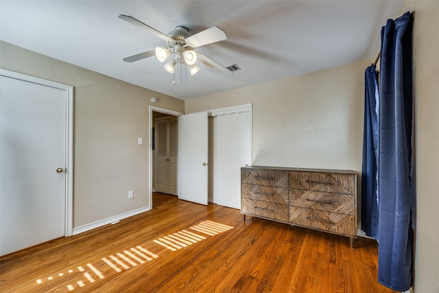 unfurnished bedroom featuring hardwood / wood-style flooring and ceiling fan