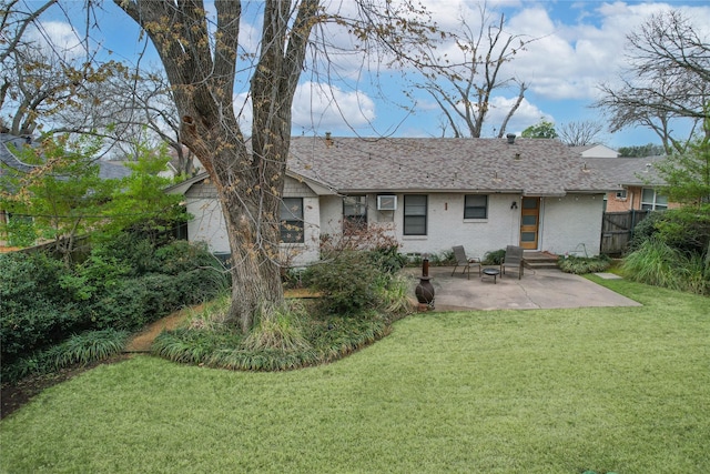 rear view of house featuring a lawn and a patio