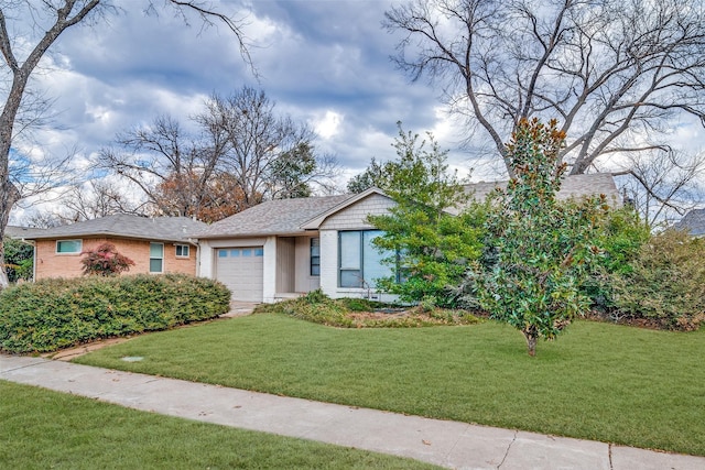 view of front of property with a garage and a front lawn