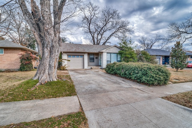 single story home featuring a front lawn and a garage