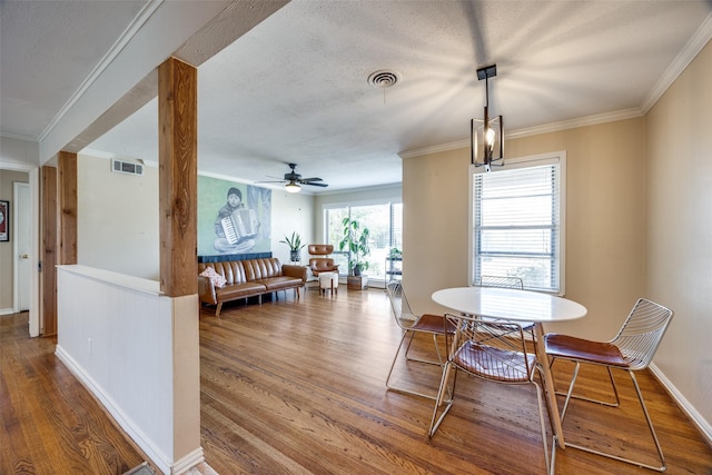 dining room featuring ceiling fan, crown molding, and hardwood / wood-style floors