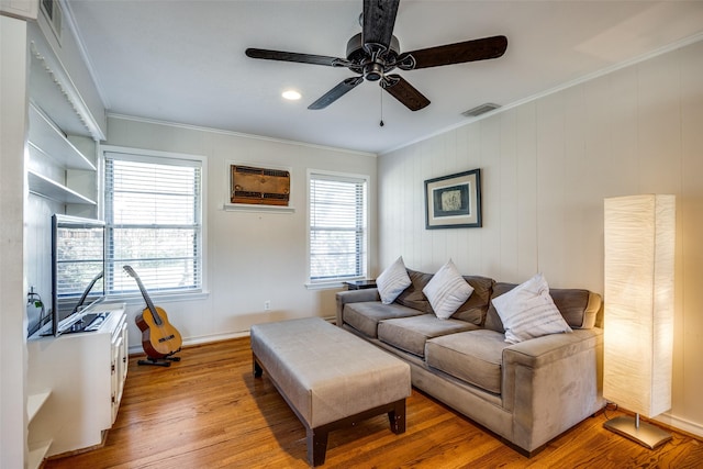 living room featuring ornamental molding, ceiling fan, and light hardwood / wood-style floors