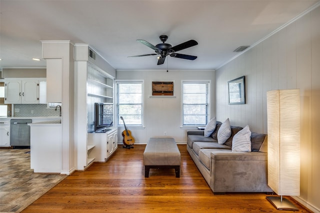 living room featuring ceiling fan, ornamental molding, and hardwood / wood-style floors