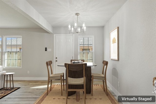 dining space with a chandelier and light hardwood / wood-style floors