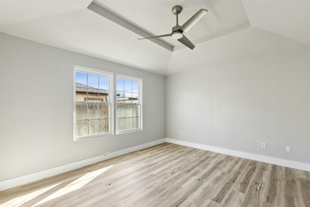 spare room featuring ceiling fan, vaulted ceiling, and light hardwood / wood-style flooring