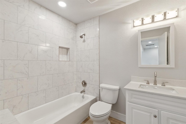 full bathroom featuring vanity, toilet, and tiled shower / bath