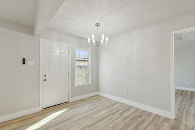 interior space with a notable chandelier and light wood-type flooring