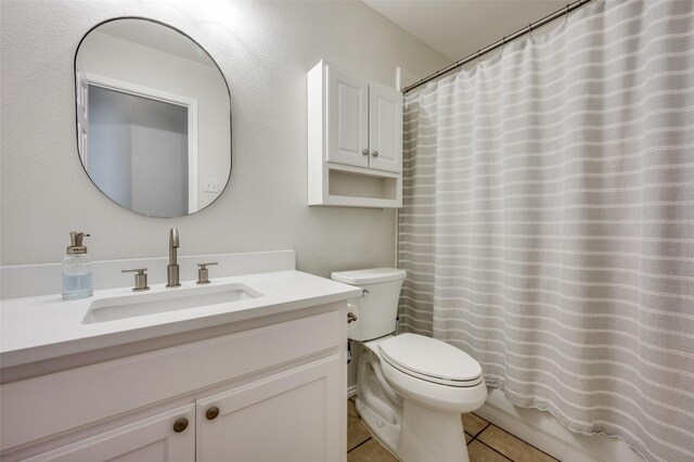 full bathroom with tile patterned flooring, vanity, toilet, and shower / tub combo