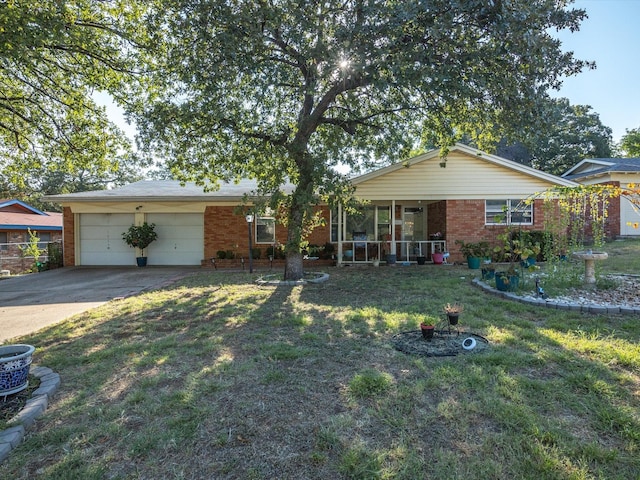 ranch-style home featuring a porch, a garage, and a front yard