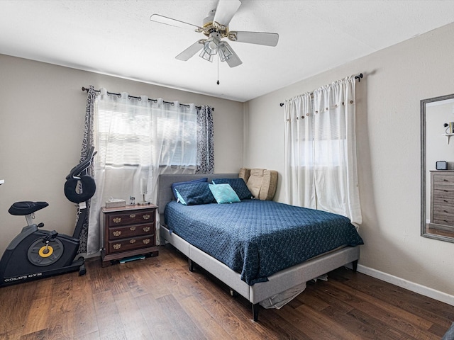 bedroom with dark hardwood / wood-style floors and ceiling fan