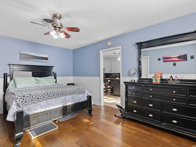 bedroom with ceiling fan and hardwood / wood-style floors