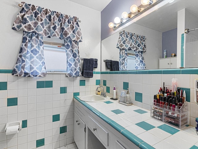 bathroom with vanity and tile walls