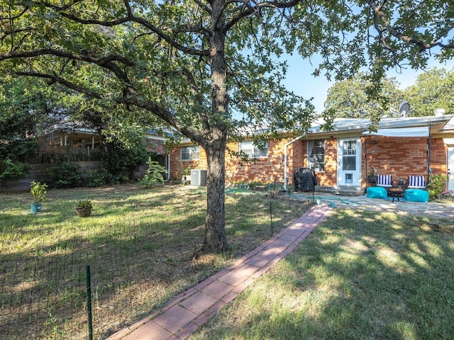 single story home with central AC and a front yard