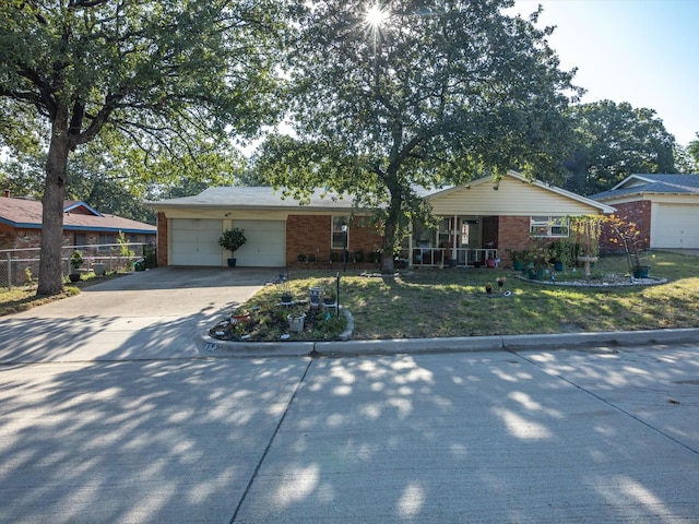 single story home featuring a garage, a front yard, and a porch