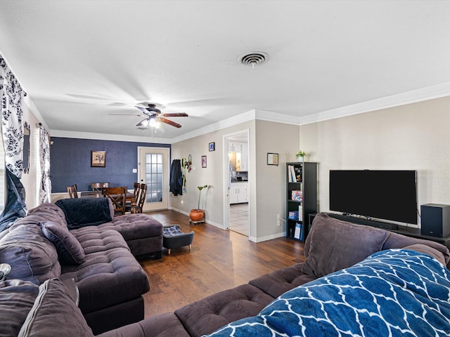 living room with hardwood / wood-style flooring, ceiling fan, and crown molding