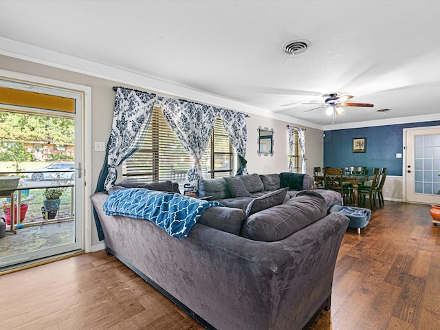 living room featuring crown molding, ceiling fan, and hardwood / wood-style flooring