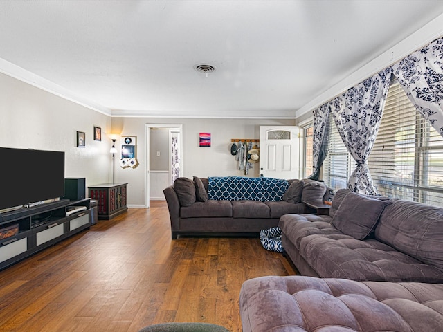 living room with crown molding and dark wood-type flooring