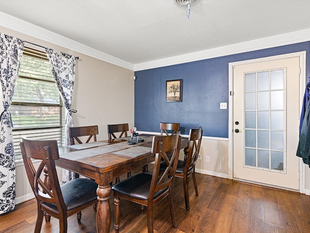 dining room featuring dark wood-type flooring and ornamental molding